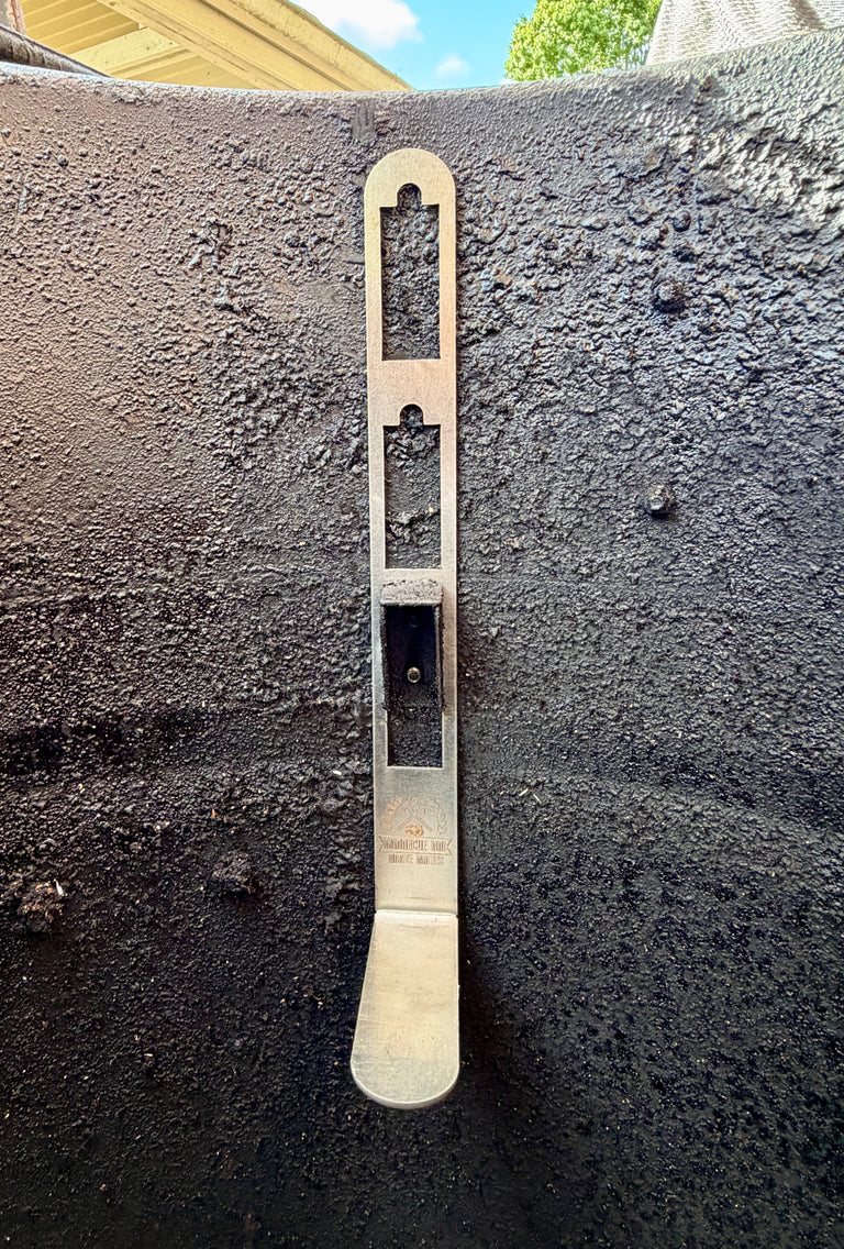 Close-up of a BBQ BOI Pit Barrel Grate Mates stainless steel support bracket installed inside a Pit Barrel Cooker