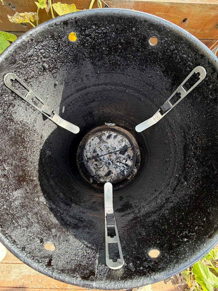 BBQ BOI Pit Barrel Grate Mates installed at three adjustable positions inside a Pit Barrel Cooker for versatile cooking grate support